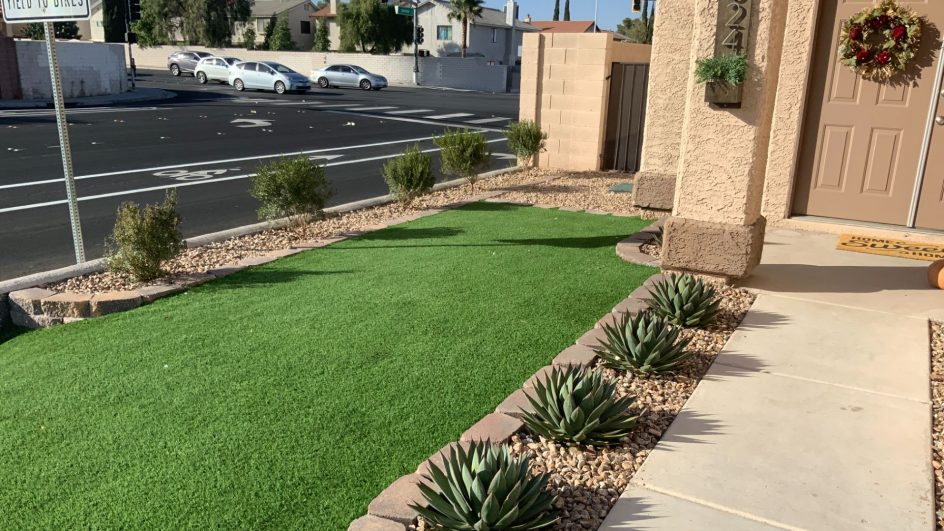 A Well-Landscaped Front Yard With Artificial Grass.